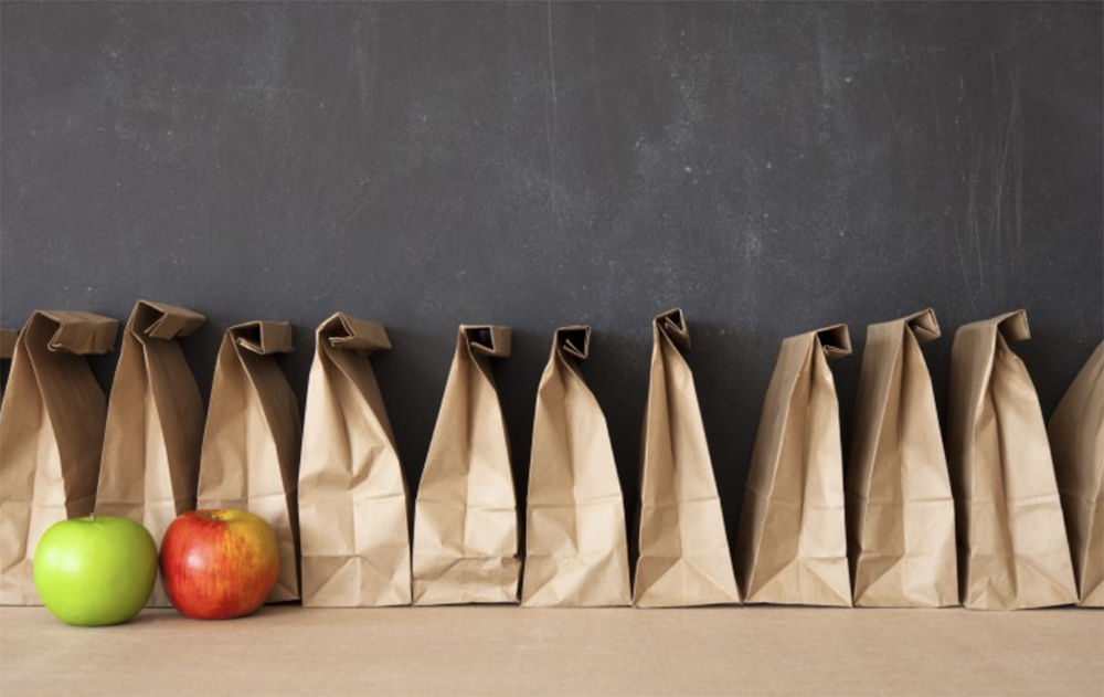brown paper lunch bags, green apple, red apple